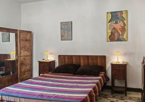 a bedroom with a bed with a colorful blanket at Nautilus in Cuglieri