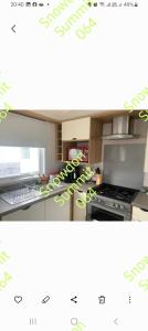 a picture of a kitchen with a stove top oven at Snowdon summit 064 in Barmouth