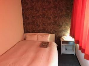 Una cama o camas en una habitación de Heal In Yokkaichi