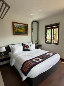 a bedroom with a large bed and a window at Sun Hill Villa in Lao Cai