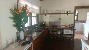 a kitchen with a sink and a microwave at The Barn in Bangalow