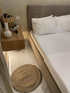 a bedroom with a bed with a table and a rug at Boho Nest in Mytilene