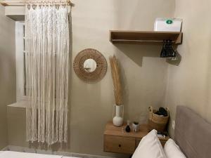 a bedroom with a bed and a table with a mirror at Boho Nest in Mytilene