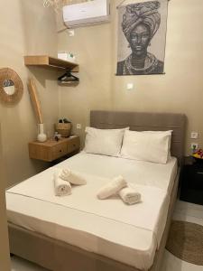 a bedroom with a bed with two towels on it at Boho Nest in Mytilene