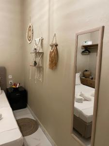 a bedroom with two beds and a mirror at Boho Nest in Mytilene +23 photos