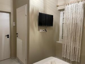 a bathroom with a flat screen tv on the wall at Boho Nest in Mytilene