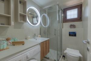 a bathroom with a shower and a sink and a toilet at Millstone Summerhouse in Pachis +42 photos