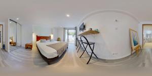 a bedroom with a bed and a room with a mirror at Les Digues Vauban in Ciboure