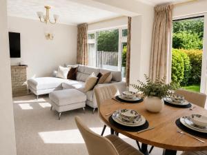 a living room with a table and chairs at Three Bed Detached Property in Frimley