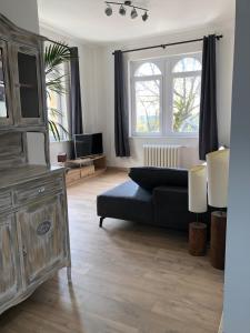 a living room with a couch and a large window at Spacious apartment in an authentic Mansion in Brussels