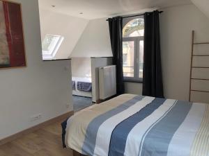a bedroom with a bed and a window at Spacious apartment in an authentic Mansion in Brussels