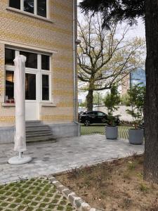 a white statue in front of a house at Spacious apartment in an authentic Mansion in Brussels