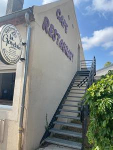a sign on the side of a building with stairs at Ideal famille Séjour le pal in Diou