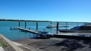 a truck parked at a dock with a boat at Matildas End Holiday Units in Karumba