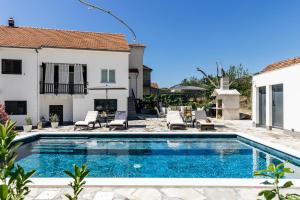 a swimming pool in the backyard of a house at Studio Deluxe RoMa II in Imotski