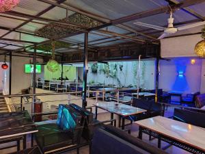 a restaurant with tables and chairs in a room at Novo Axora Lounge & Accommodation Kimbo Ruiru Kimbo Lopha Stage in Ruiru +8 photos