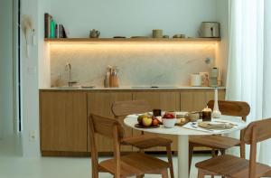 a kitchen with a table with fruit on it at NIEL71 Suite in Kerniel +17 photos