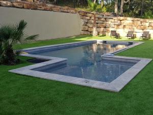 a swimming pool in the middle of a yard at Villa Saona in Le Plan-de-la-Tour