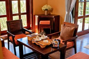a living room with a table and two chairs at Cloud Paradise Resort in Lao Cai