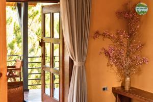 a living room with a curtain and a window at Cloud Paradise Resort in Lao Cai