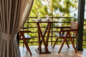 a table and two chairs on a balcony at Cloud Paradise Resort in Lao Cai