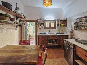 a kitchen with a wooden table and a kitchen with a sink at Nautilus in Cuglieri +31 photos