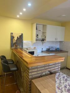 a kitchen with a wooden counter in a room at Apartman Mijovic - Nova Varos in Nova Varoš