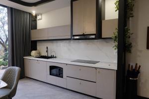 a kitchen with white cabinets and a stove top oven at Sun Hill Villa in Lao Cai +42 photos