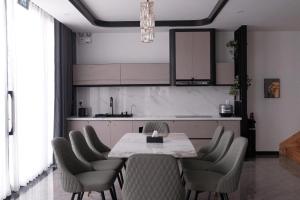 a dining room with a table and chairs in a kitchen at Sun Hill Villa in Lao Cai