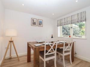 a dining room with a wooden table and chairs at Wrens Nest in Kingsbridge