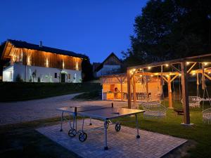 a ping pong table in front of a building at night at Chalet Village Bran in Bran