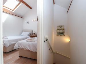 a small bedroom with a bed and a window at Wrens Nest in Kingsbridge