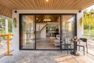 an open living room and dining room with sliding glass doors at Coco Nest in Ko Phangan