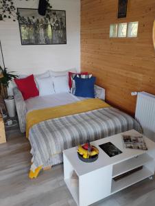 a bedroom with a bed and a table with a fruit on it at 479 Tiny House, Domeniul von Agodt in Bradu +46 photos