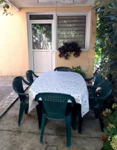 a table and chairs in front of a window at Vila Nikolic in Lastva