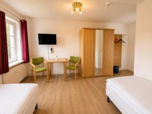 a bedroom with a desk and two chairs and a table at Schlösschen am Rhinufer in Alt Ruppin