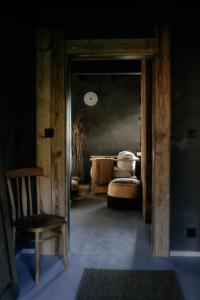 a room with a door leading to a bedroom with beds at Flumen MIkoszewo in Skorka