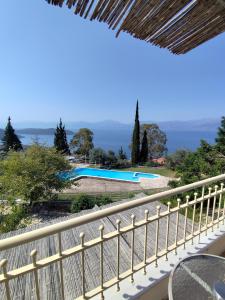 a view of a pool from the balcony of a house at Hotel Theasis in Paralía Sergoúlas