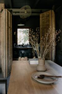 a table with a plate and a vase on it at Flumen MIkoszewo in Skorka +17 photos