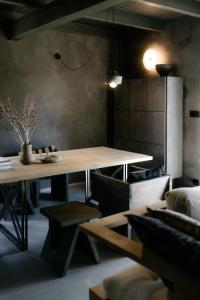 a dining room with a wooden table and chairs at Flumen MIkoszewo in Skorka