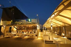 a patio with white chairs and tables on a ship at Hotel Las Vegas in Jaipur