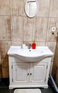 a bathroom with a white sink and a mirror at Ubytovanie Čadca 2026 in Čadca