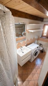 a bathroom with a sink and a toilet at ALLOGGIO CASA IN PIETRA in Santu Lussurgiu