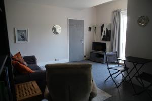 a living room with a couch and a table at Seaford Snug in Seaford