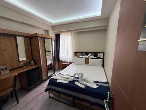 a bedroom with a bed with towels on it at Vizyon Hotel Center in Istanbul