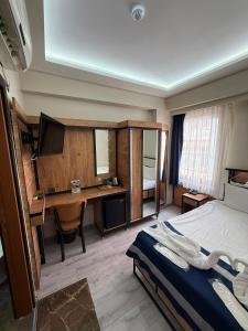 a bedroom with a bed and a desk with a computer at Vizyon Hotel Center in Istanbul