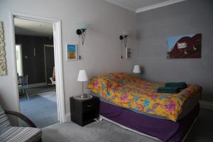 a bedroom with a bed and a lamp in it at Seaford Snug in Seaford