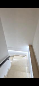a white staircase in a room with a white ceiling at Urban Nest in Vasto