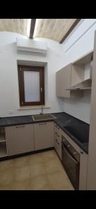 an empty kitchen with a sink and a window at Urban Nest in Vasto