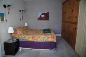 a small bedroom with a bed and a dresser at Seaford Snug in Seaford +28 photos